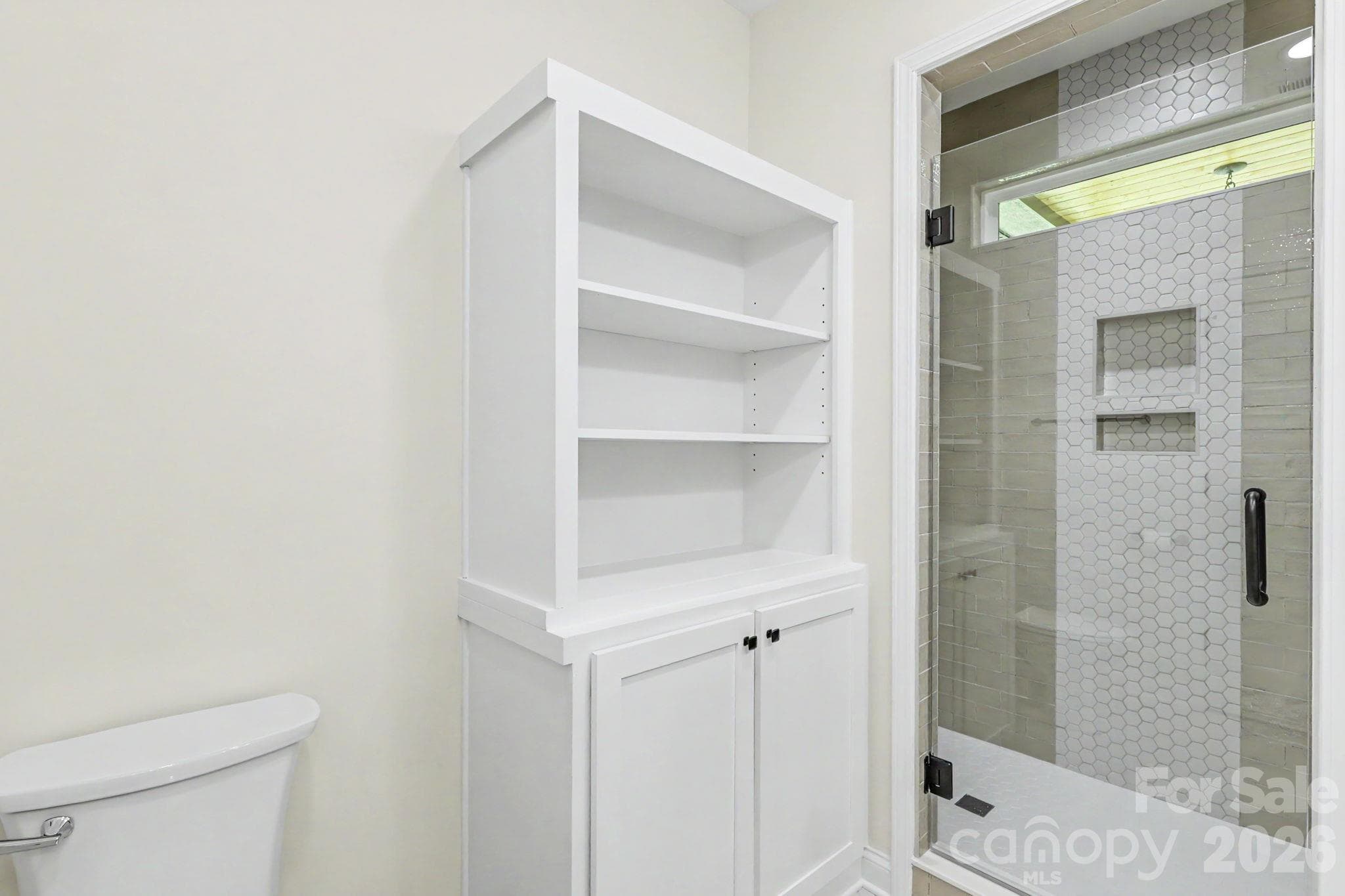 Primary bathroom with custom tile shower and cabinetry - 2121 Woodhurst Lane, Albemarle
