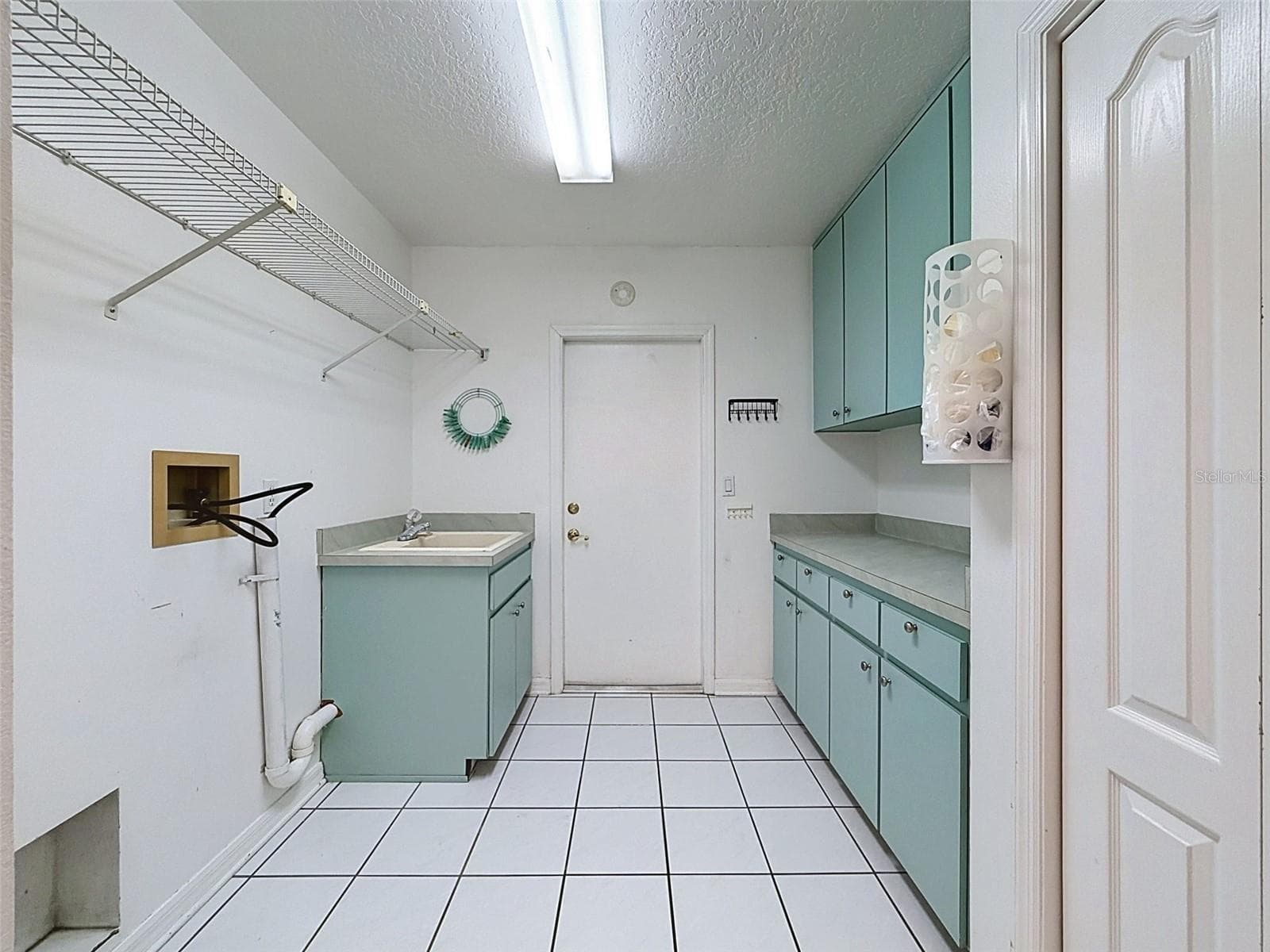 Laundry room has storage gallore! - 10074 SLEEPY WILLOW CT, SPRING HILL