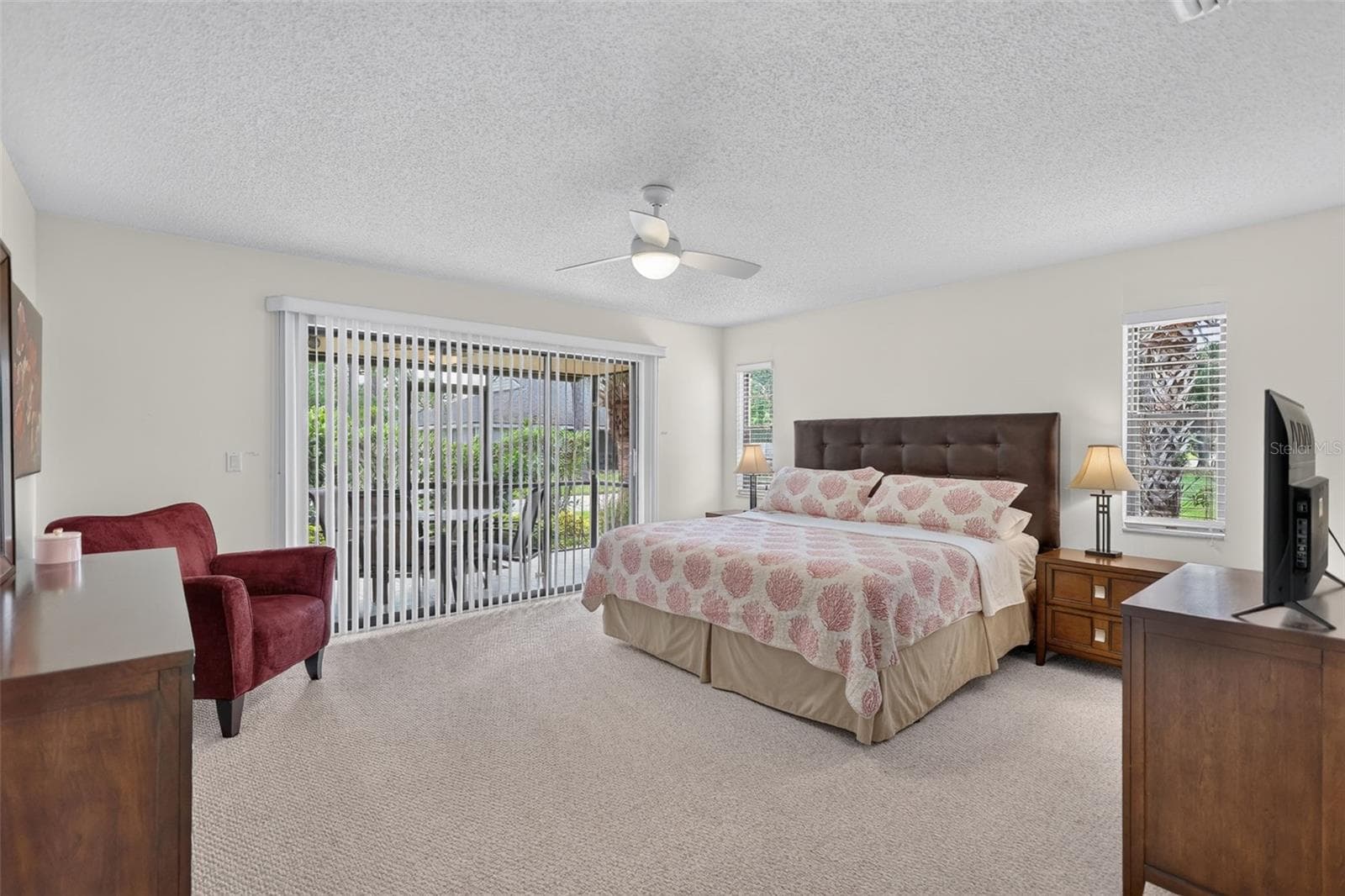 Master Bedroom is carpeted and features sliding doors to the lanai - 3728 PINECONE CT #164, SARASOTA