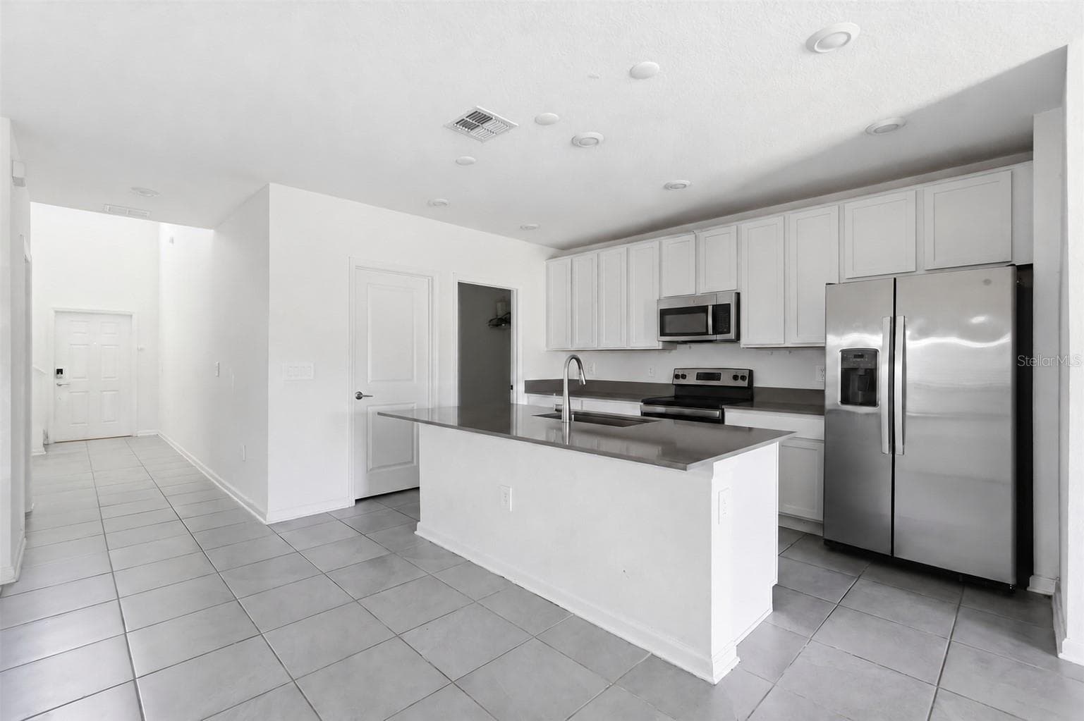 Kitchen comes with an island with stone counters - 418 COOL SUMMER LN, DAVENPORT