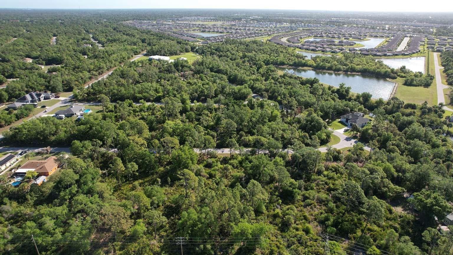 Aerial view of the surrounding area; nearby water features are not part of this property and do not establish access rights. - 1532 CHAFFIN LN, PORT CHARLOTTE