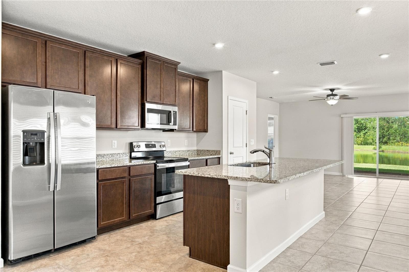 Kitchen View with Appliances and Island - 17973 DAIRY FARM CT, LAND O LAKES