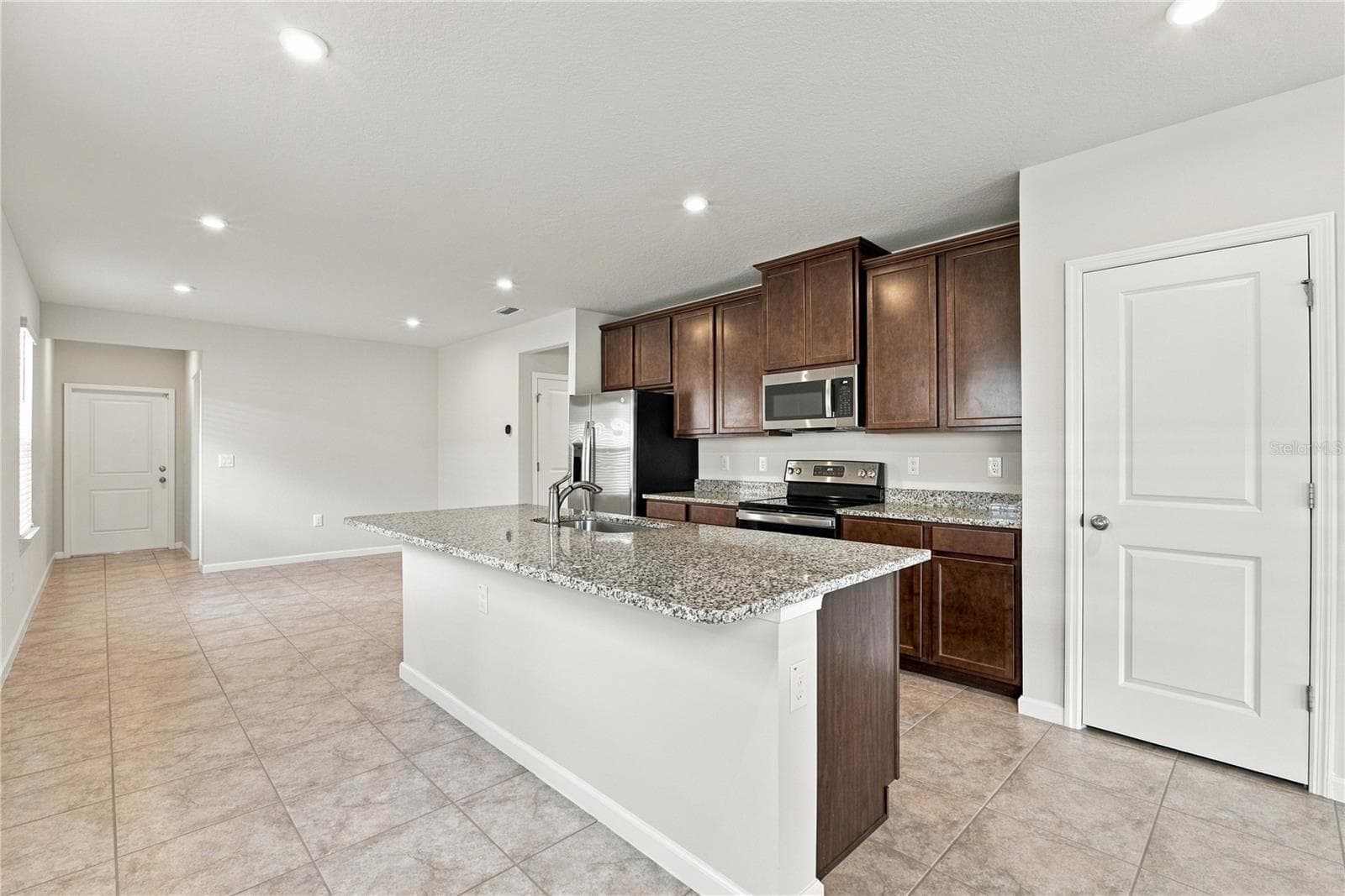 Kitchen and walk in pantry from Fam Rm - 17973 DAIRY FARM CT, LAND O LAKES