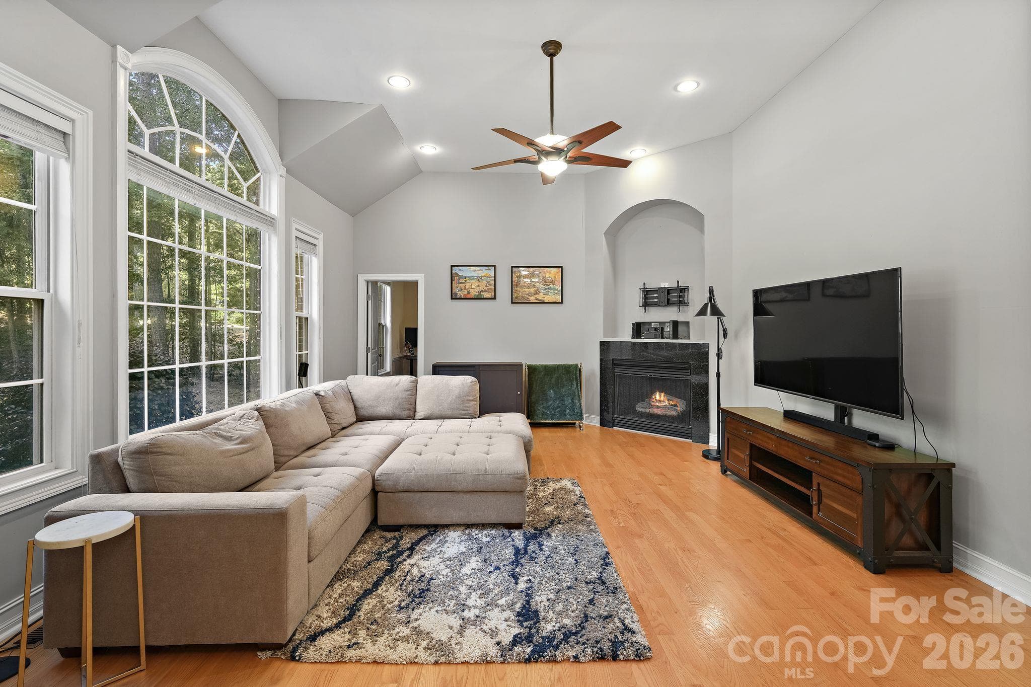 Vaulted ceilings, a cozy fireplace, and large windows allowing for tons of natural light - 1491 Woodbend Court, Stanley