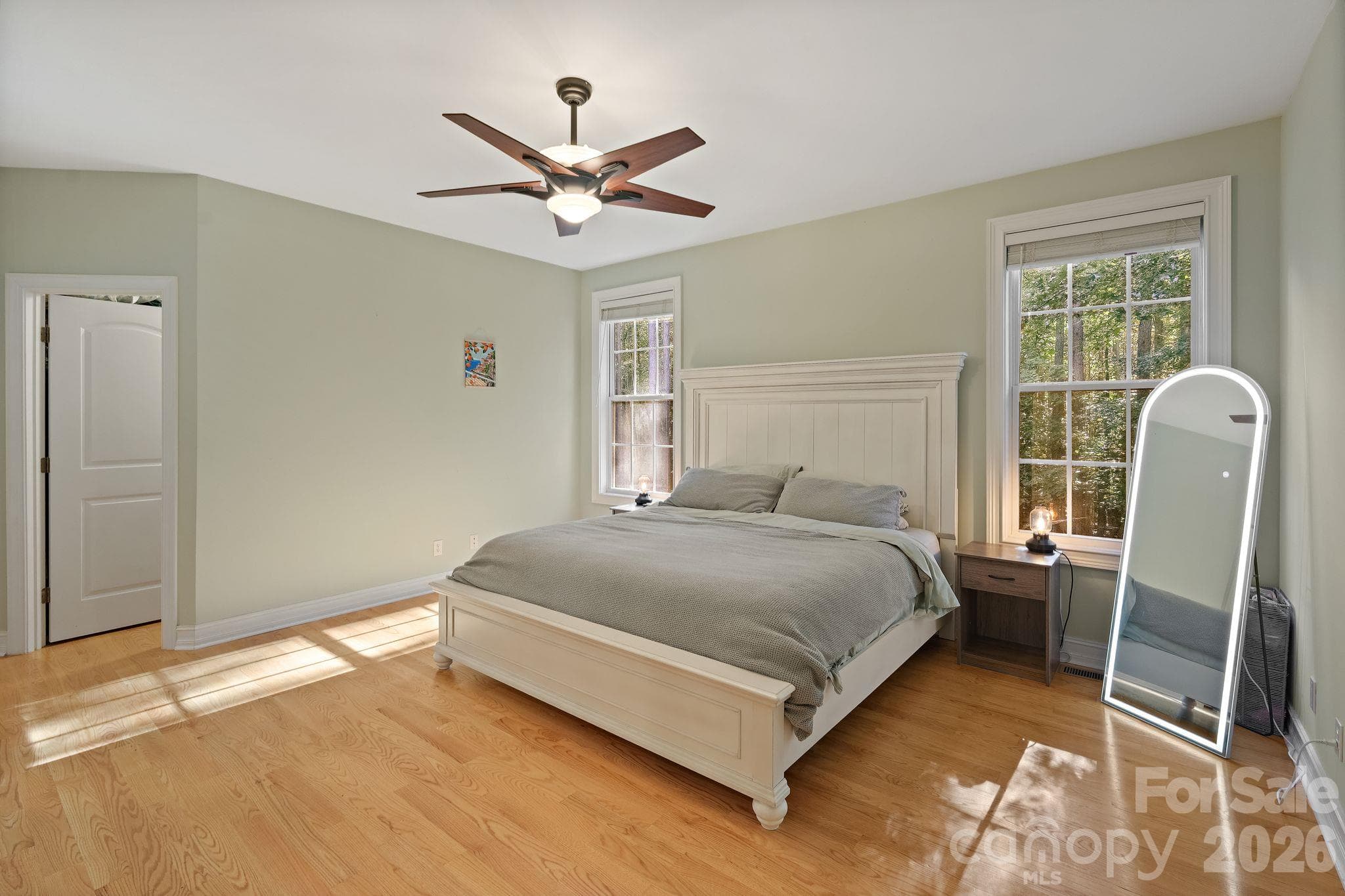 Spacious main level primary suite with walk-in closet and backyard views - 1491 Woodbend Court, Stanley