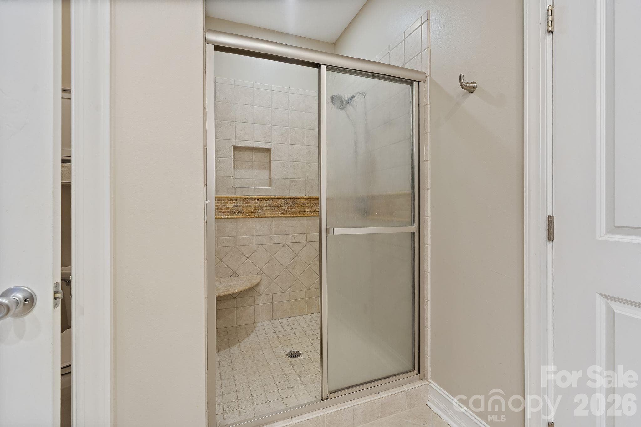 Walk-in tile shower with corner bench - 1491 Woodbend Court, Stanley