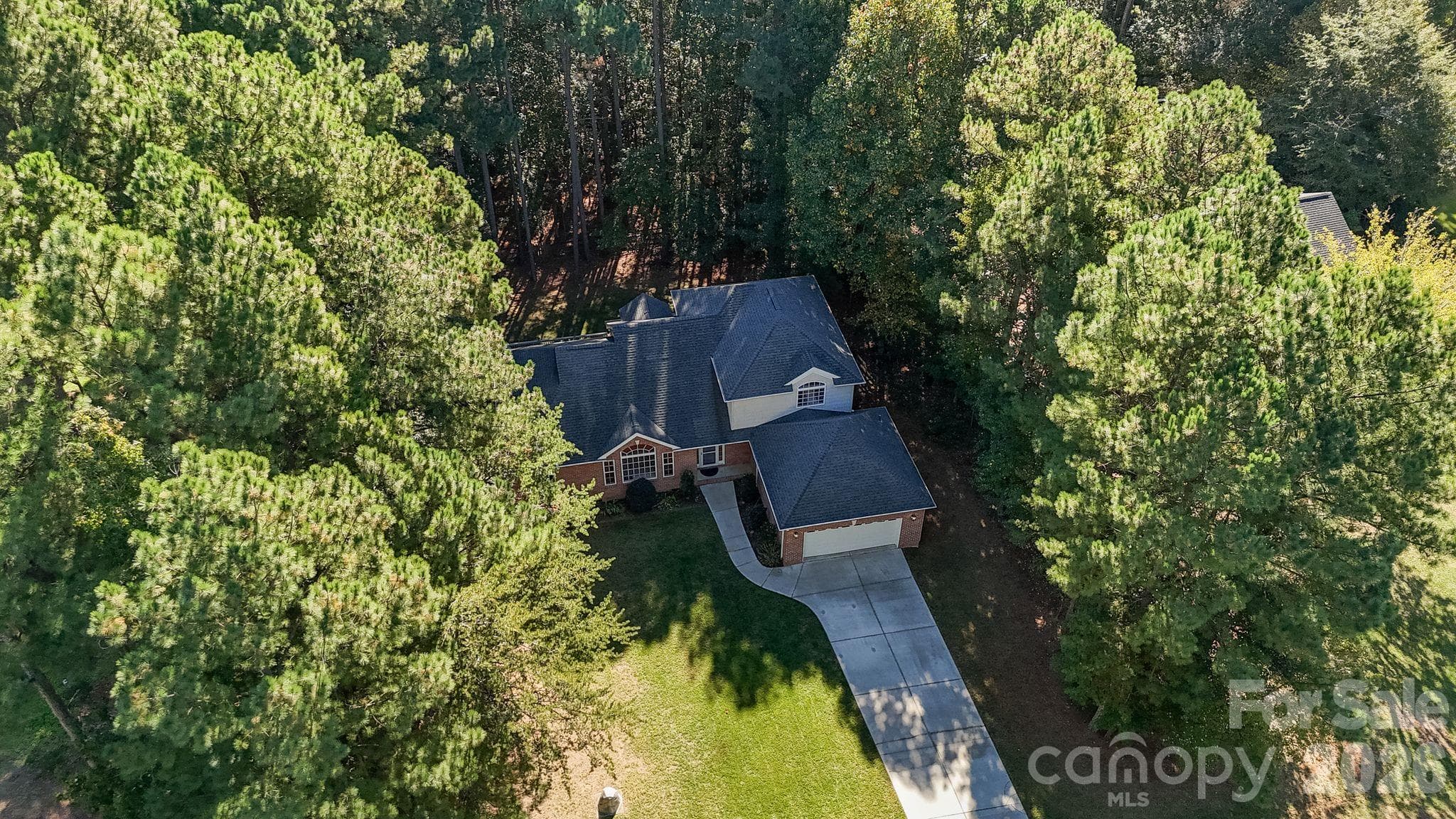 Mature trees and lush greenery offer a serene, private setting - 1491 Woodbend Court, Stanley