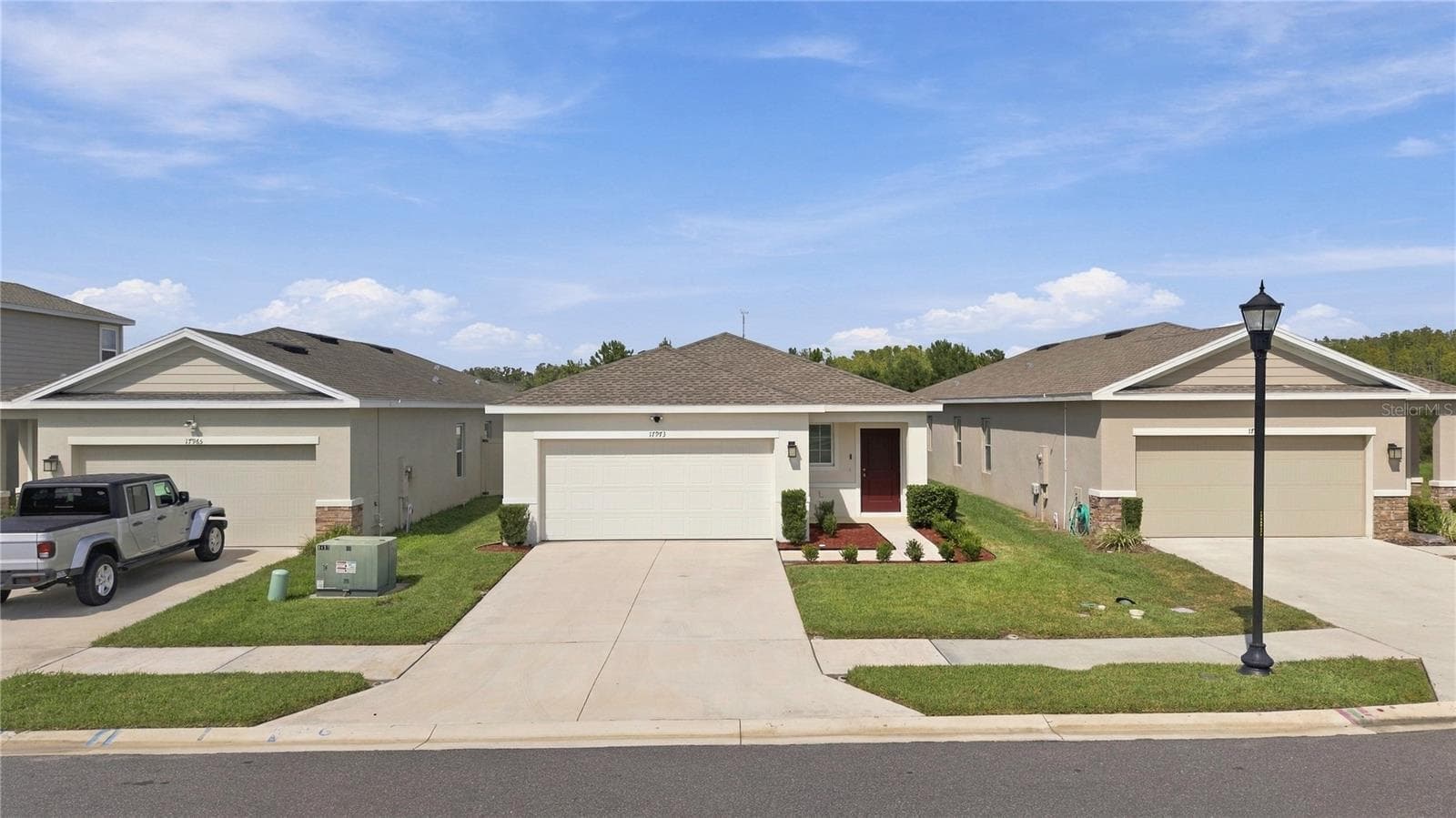 Home as Viewed with Neighbors on each side - 17973 DAIRY FARM CT, LAND O LAKES