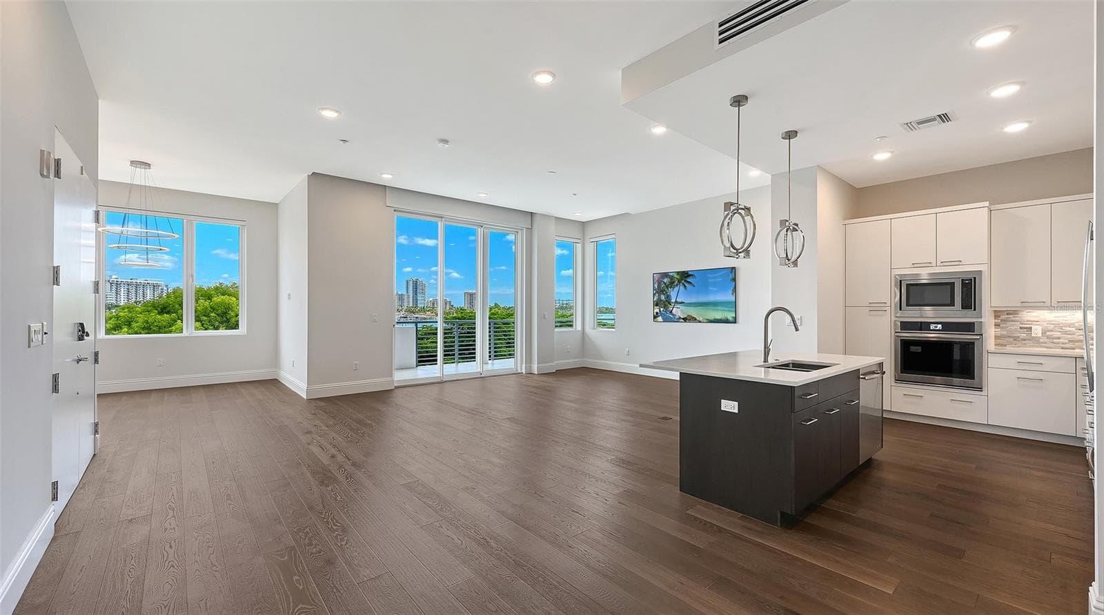 Photo of the whole living area out onto the lanai. - 609 GOLDEN GATE PT #301, SARASOTA