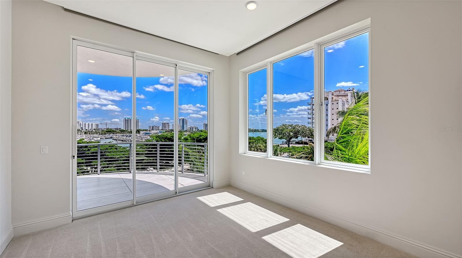 Sitting area in primary bedroom w sliders out to front lanai - 609 GOLDEN GATE PT #301, SARASOTA