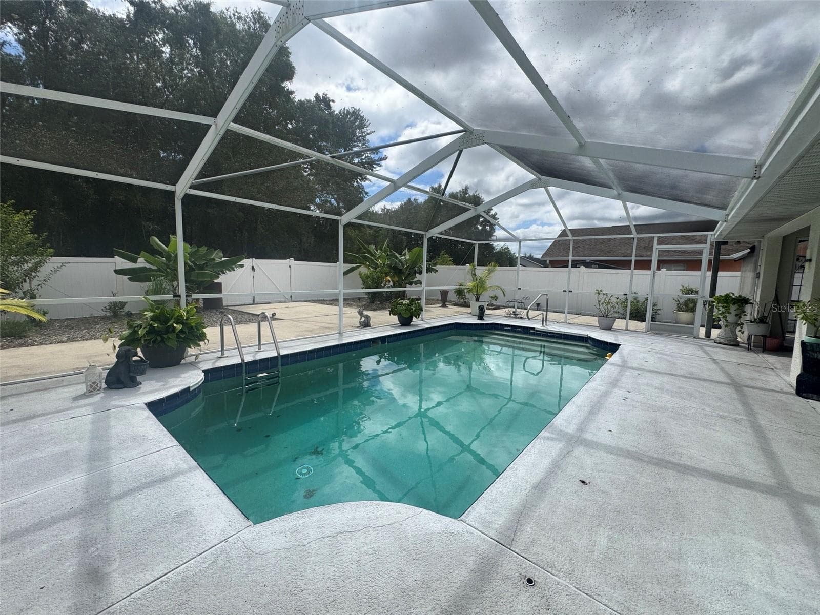 In-ground concrete pool screened - 4470 SW 132 PL, OCALA