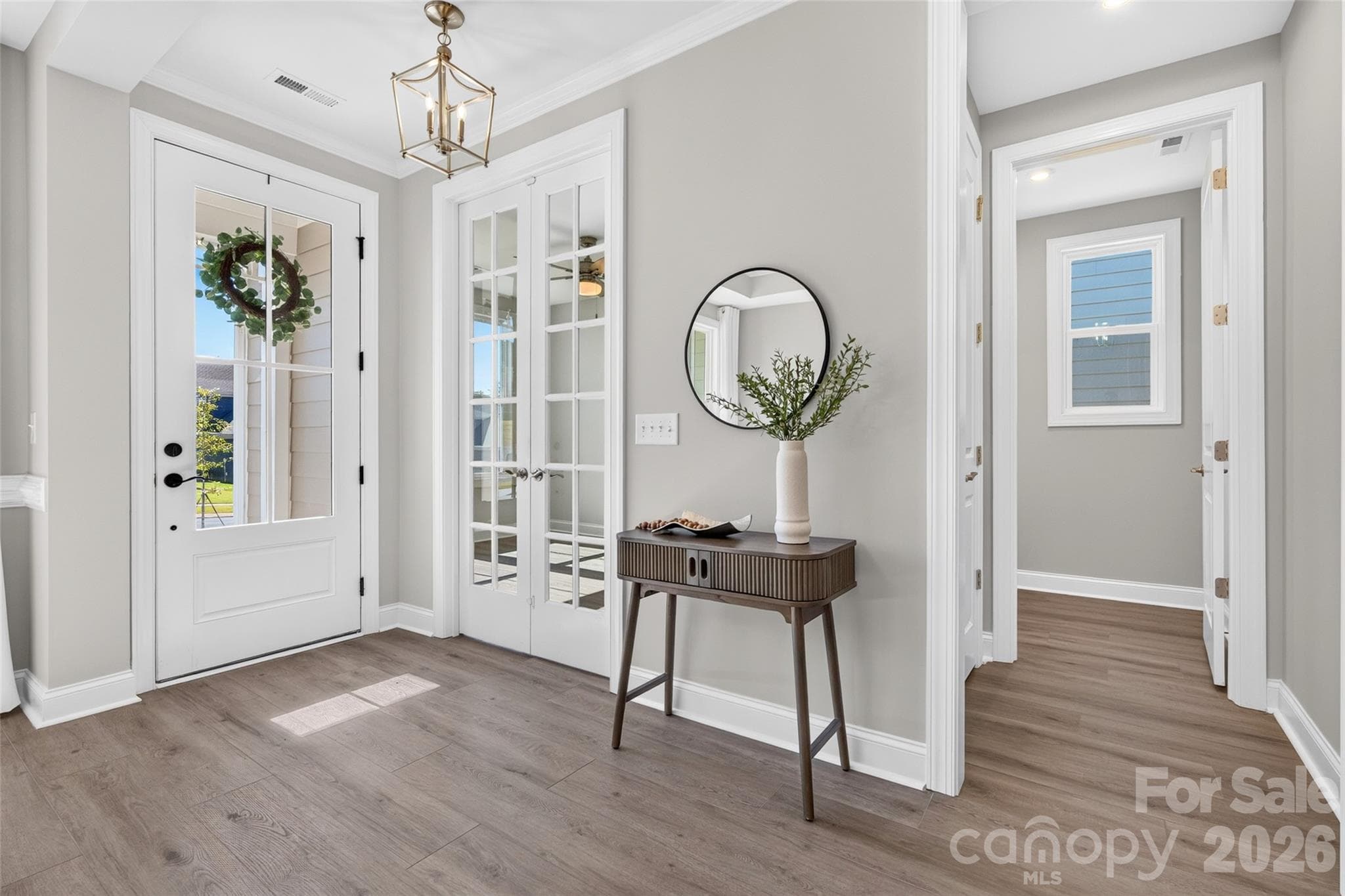 Gorgeous 4-lite glass front door brings elegance as well as natural light into this inviting Foyer - 13413 Cozy Court, Charlotte