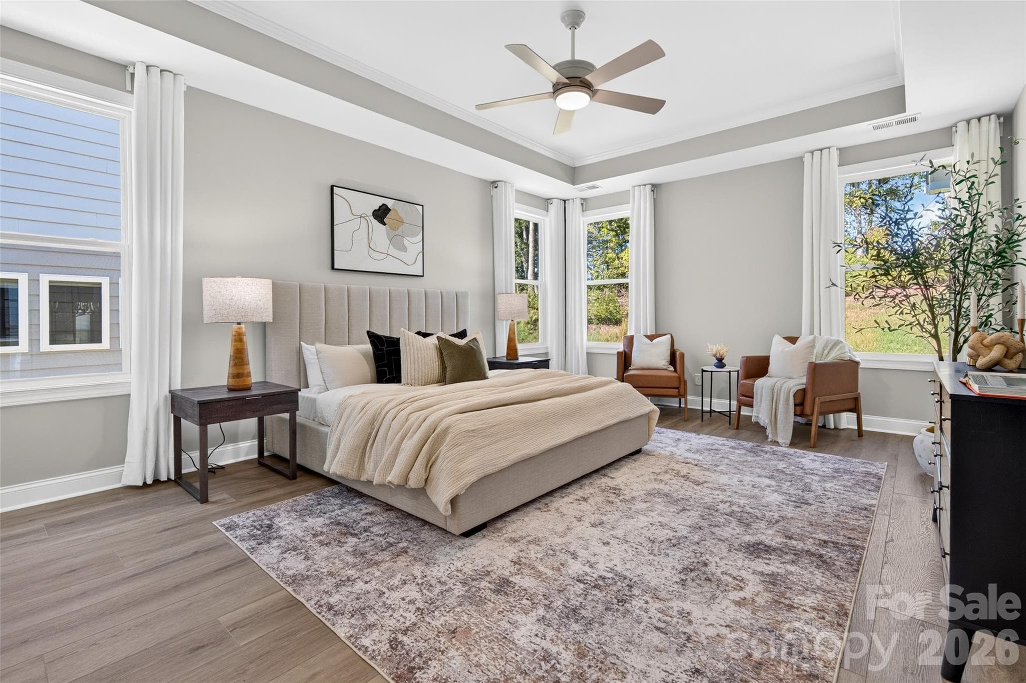 Huge Primary Suite features plenty of natural light, low maintenance flooring, neutral paint, tray ceiling and upgraded fan/light fixture - 13413 Cozy Court, Charlotte