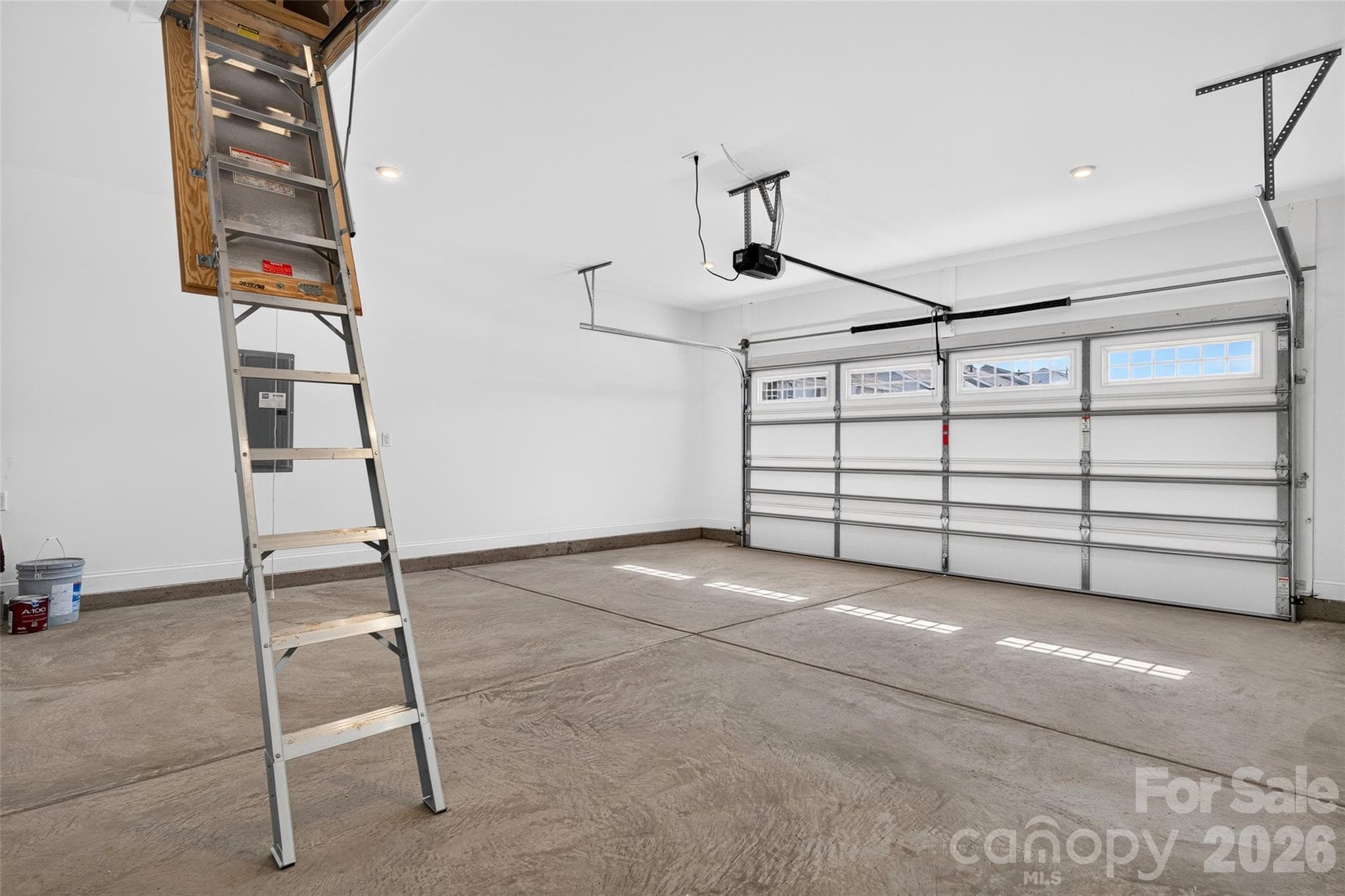 Garage has attic stairs pulldown with metal stairs and light attic storage - 13413 Cozy Court, Charlotte