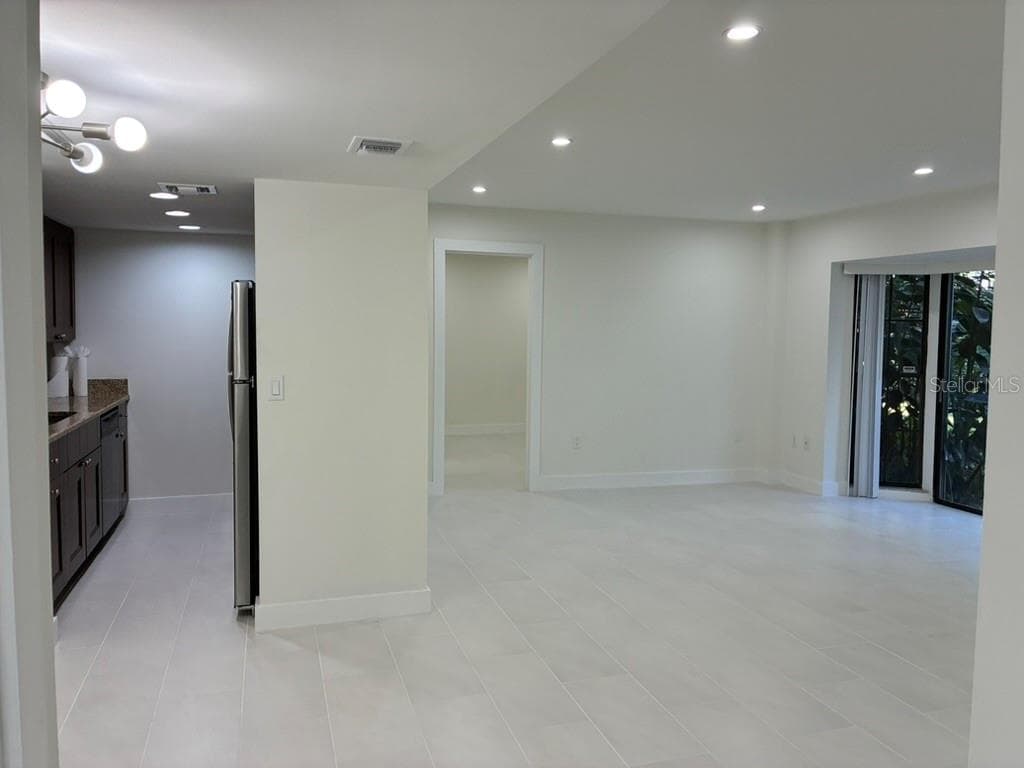 Living room and Kitchen from front door - 5999 VILLAGE CIR #990, ORLANDO