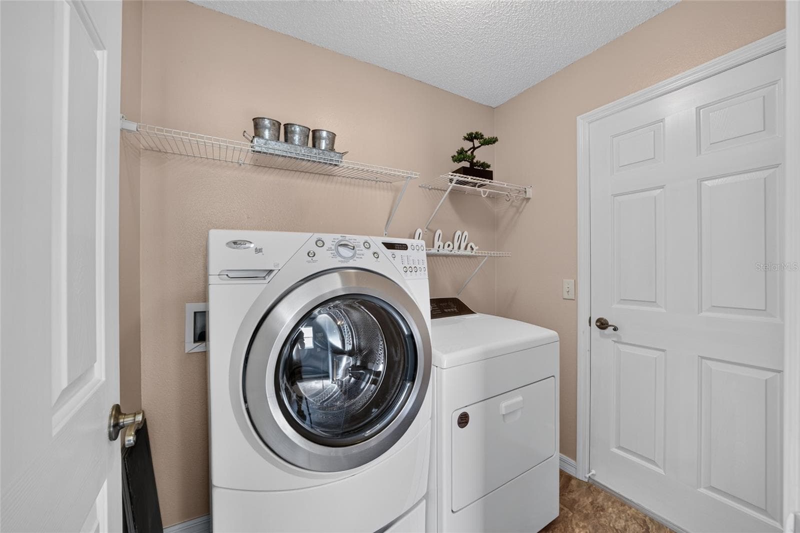 LAUNDRY ROOM OFF PRIMARY BATH TO GARAGE - 16758 SE 84TH COLERAIN CIR, THE VILLAGES