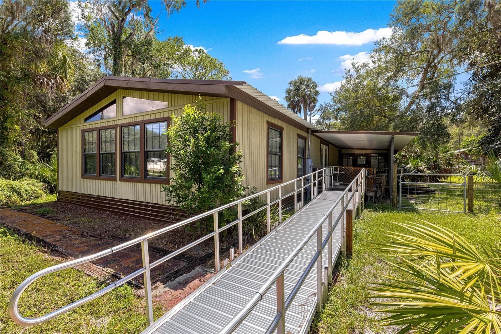 #1 · Ramp approach to the main residence. - 7434 E CABIN LN, INVERNESS