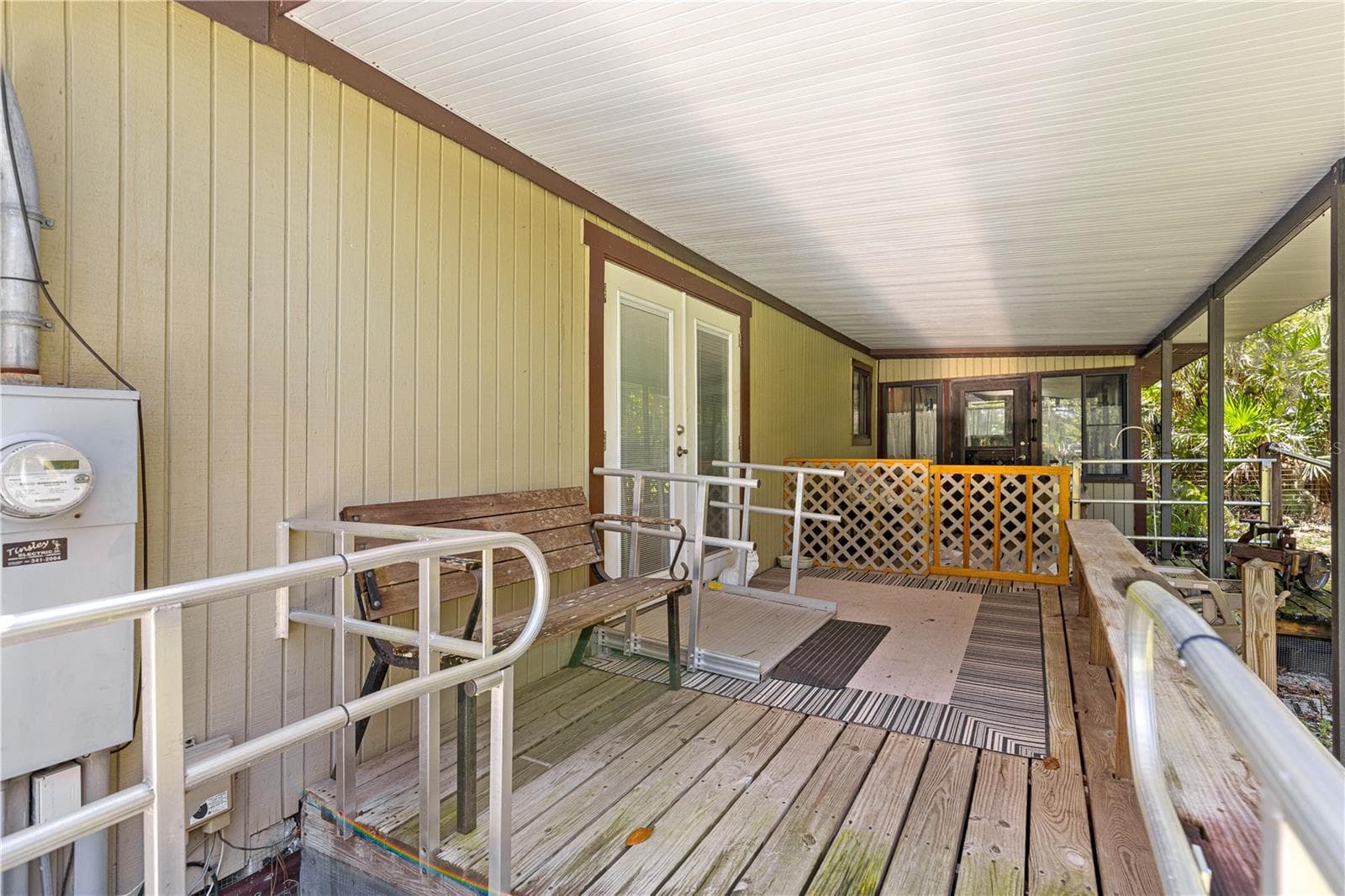#1 · Covered entrance porch and ramp landing. - 7434 E CABIN LN, INVERNESS