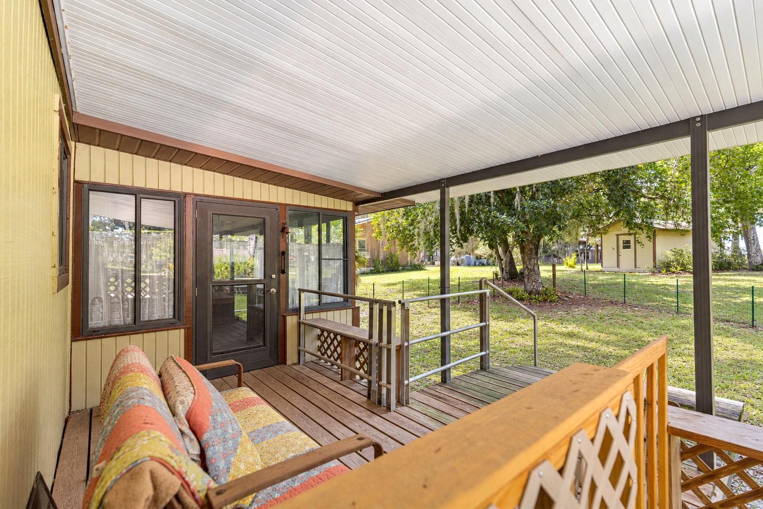 #1 · Covered porch beside the main residence. Virtually staged—personal items digitally removed. - 7434 E CABIN LN, INVERNESS