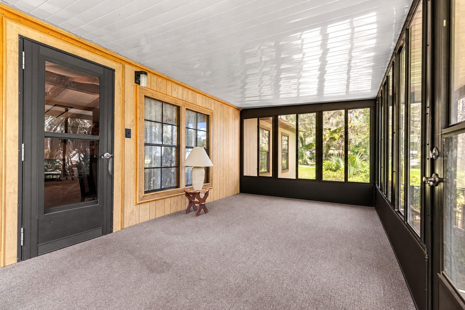 #1 · Enclosed porch at the main residence. Virtually staged—personal items digitally removed. - 7434 E CABIN LN, INVERNESS