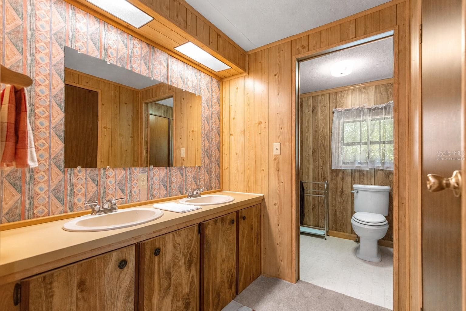 #1 · Double-vanity bathroom. Virtually staged—personal items digitally removed. - 7434 E CABIN LN, INVERNESS