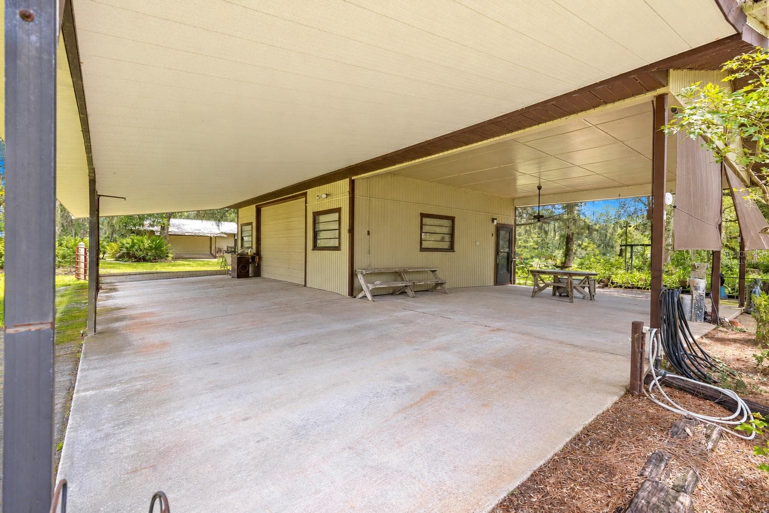#2 · Mechanic’s shop, connected covered areas. Virtually staged—personal items digitally removed. - 7434 E CABIN LN, INVERNESS