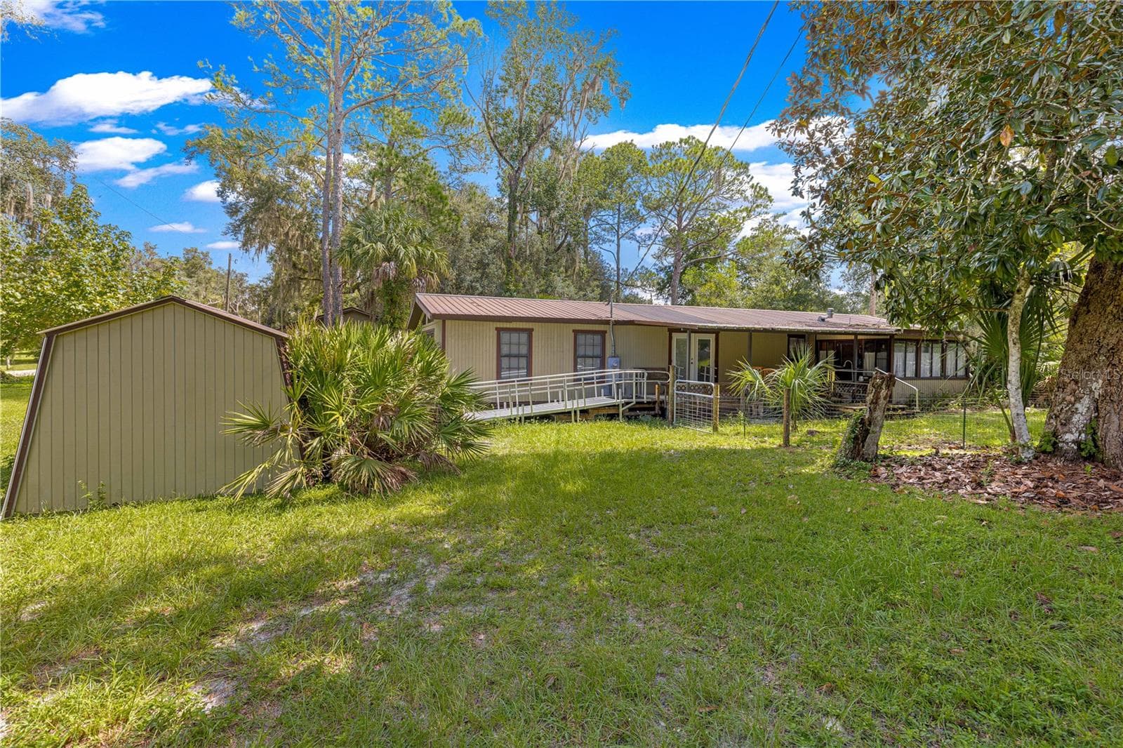 #5 · Well house / water filtration: exterior at left. - 7434 E CABIN LN, INVERNESS