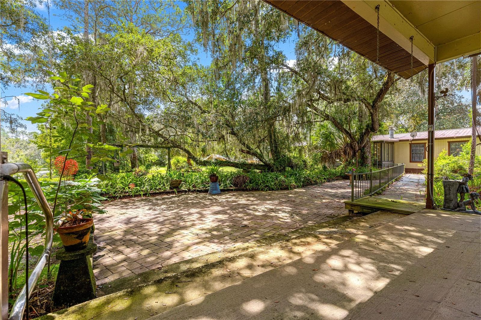Courtyard and garden view from the covered shop area. - 7434 E CABIN LN, INVERNESS