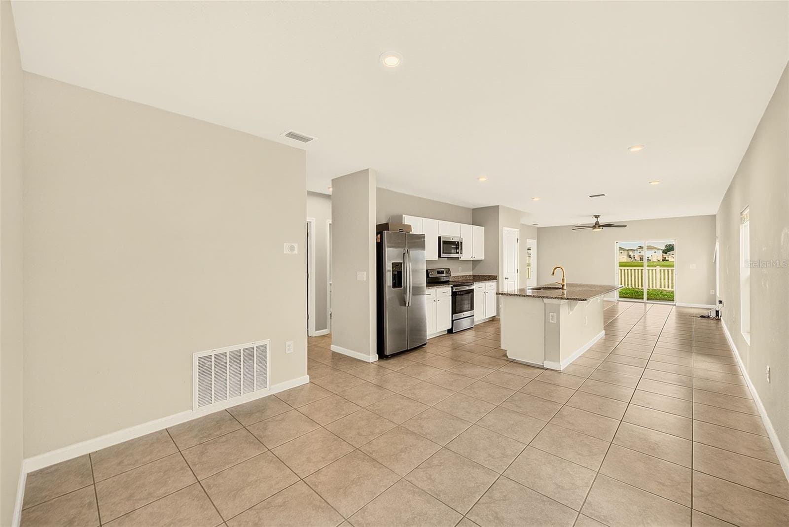 DINING TO KITCHEN TO GREAT ROOM - 35235 GENDRY ST, ZEPHYRHILLS