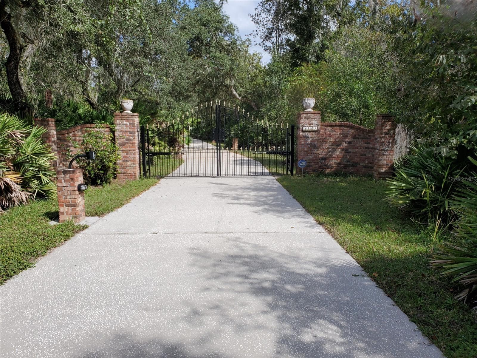 Electronic steel gate at front of 405 foot driveway. - 5422 CYRIL DR, DADE CITY