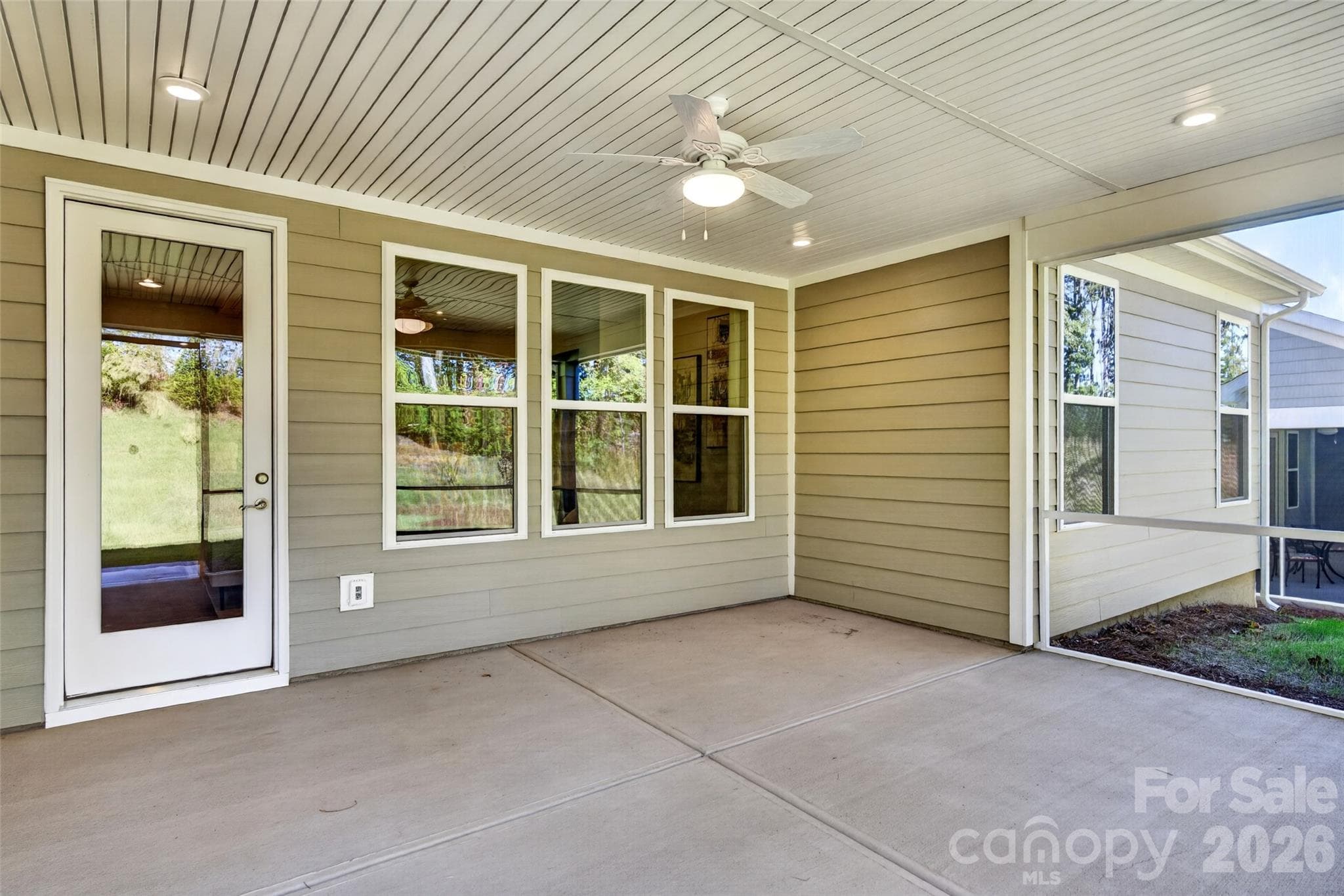 Added recessed lighting and ceiling fan on the extended rear screened porch for year-round comfort - 13413 Cozy Court, Charlotte