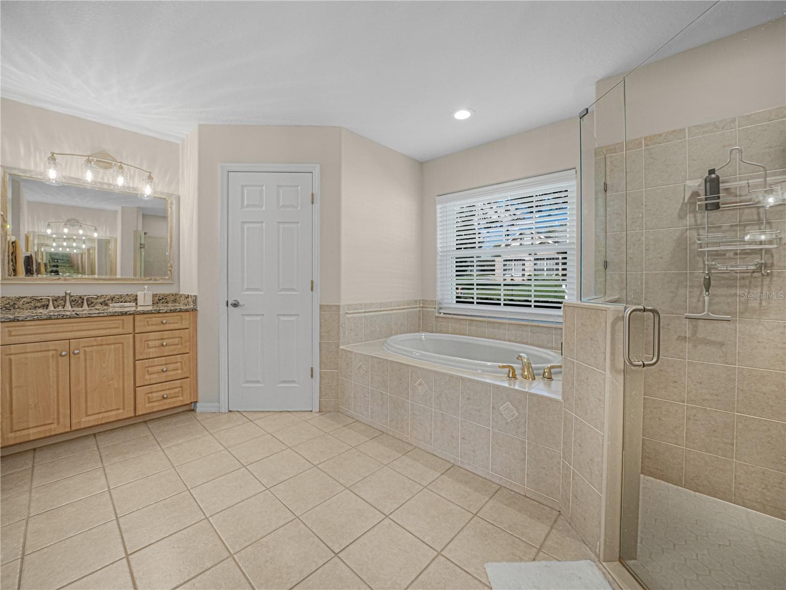 Primary Bathroom has walk in shower and oversized garden tub - 5868 HIGH RIDGE LOOP, LAKELAND