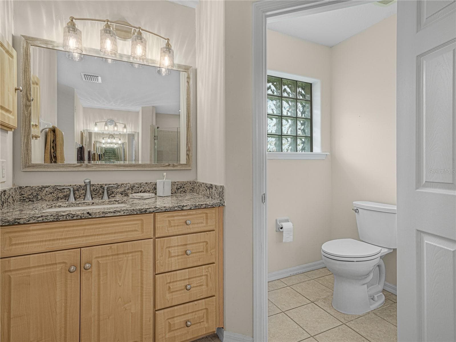 Primary bathroom has dual vanities and a separate water closet - 5868 HIGH RIDGE LOOP, LAKELAND