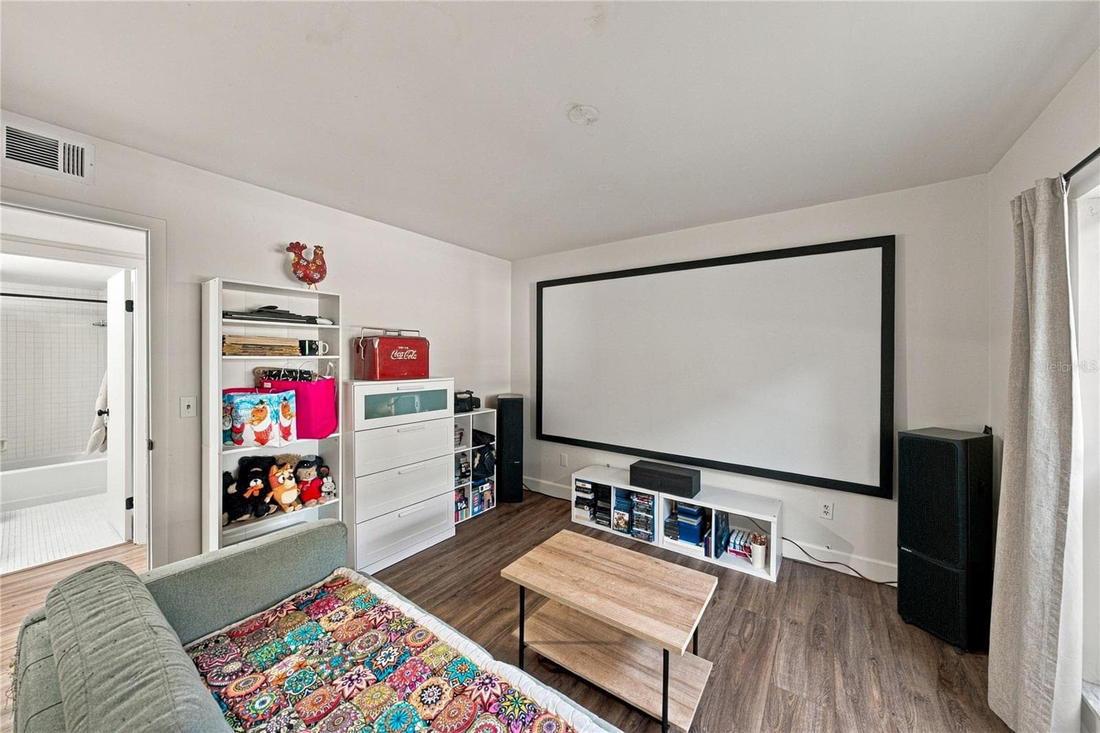 Second Bedroom used as a Movie Room with Plank Flooring and Large Closet - 4106 PINELAKE LN #101, TAMPA