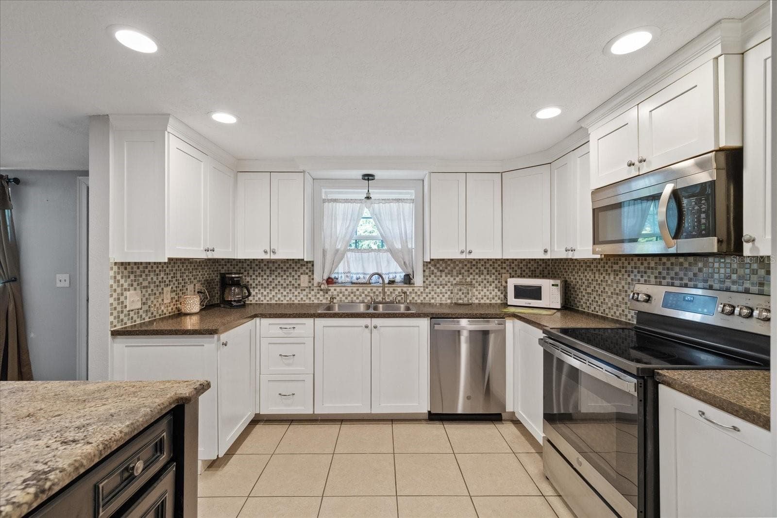 Large open Kitchen with window over the sink - 5412 CARLTON RD, NEW PORT RICHEY