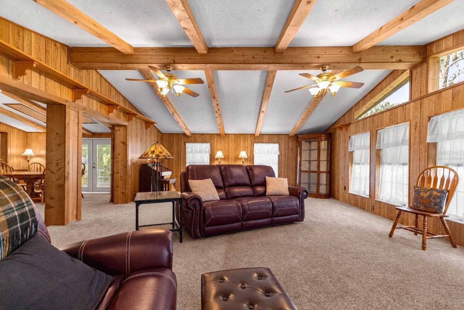 #1 · Reverse living-room view toward the dining and sitting areas. Virtually staged—personal items digitally removed. - 7434 E CABIN LN, INVERNESS