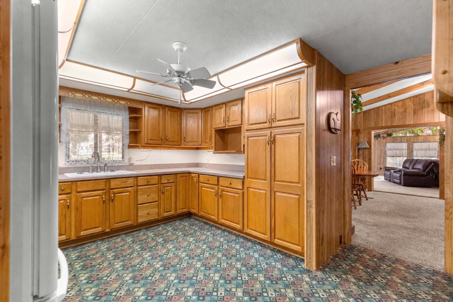 #1 · Kitchen reverse view toward the living space. Virtually staged—personal items digitally removed. - 7434 E CABIN LN, INVERNESS
