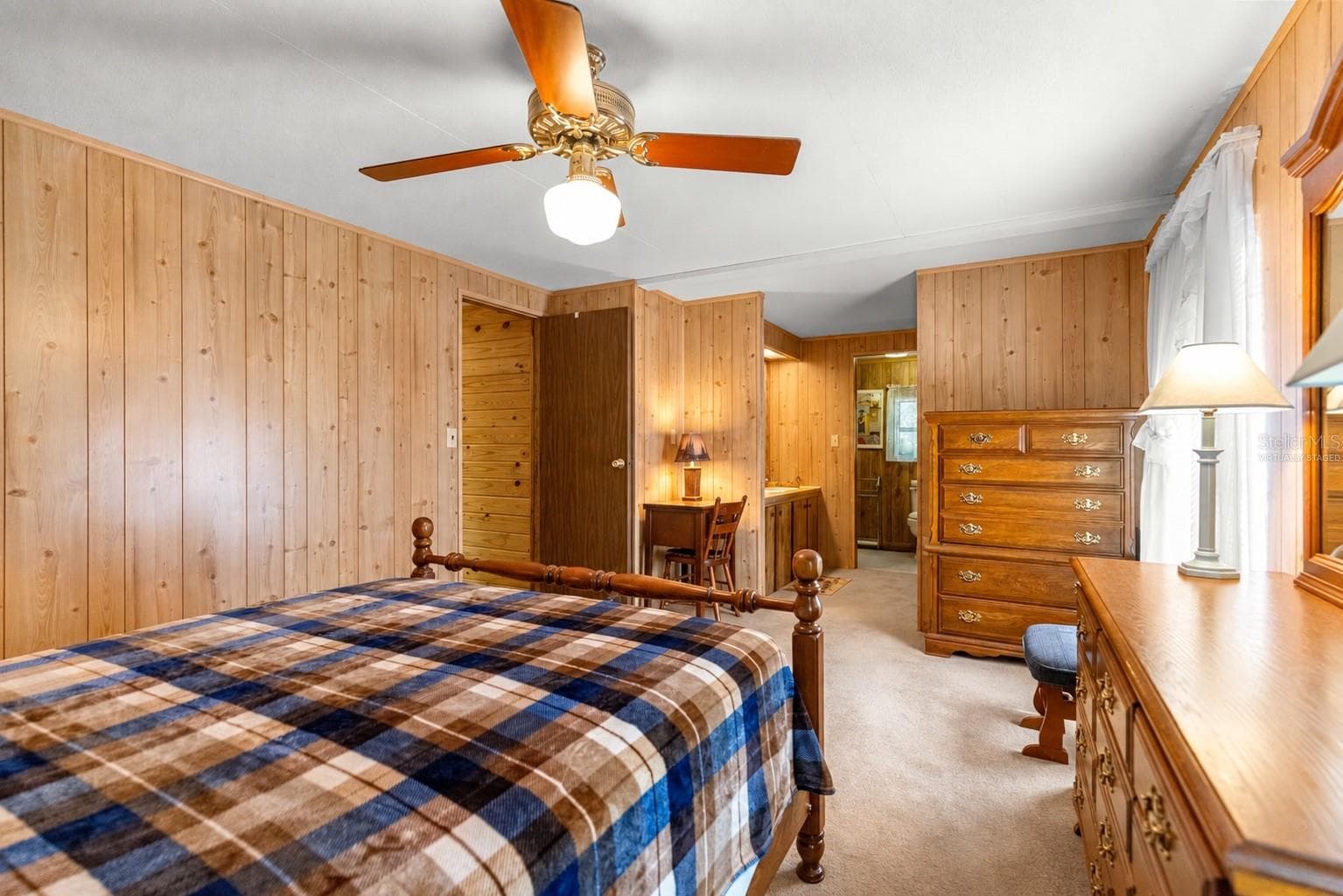 #1 · Bedroom one, reverse view toward the adjoining bathroom. Virtually staged—personal items digitally removed. - 7434 E CABIN LN, INVERNESS