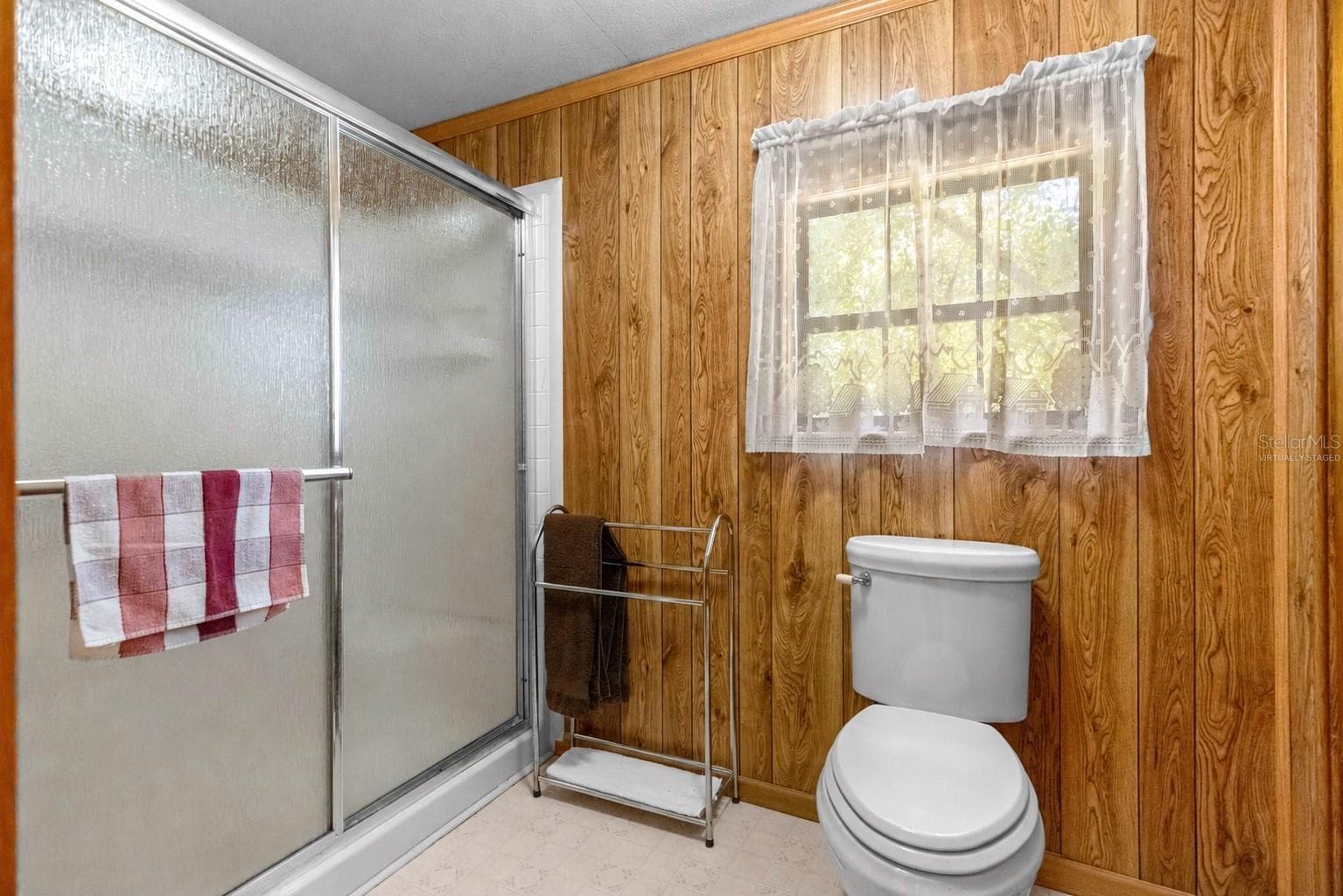 #1 · Shower and toilet area beyond the double vanity. Virtually staged—personal items digitally removed. - 7434 E CABIN LN, INVERNESS