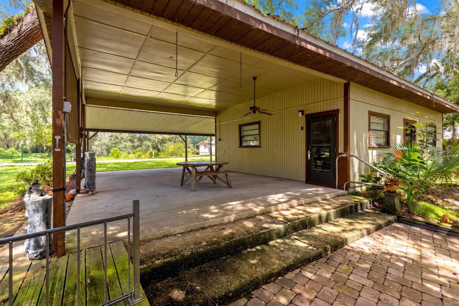 #2 · Mechanic’s shop covered porch. Virtually staged—personal items digitally removed. - 7434 E CABIN LN, INVERNESS