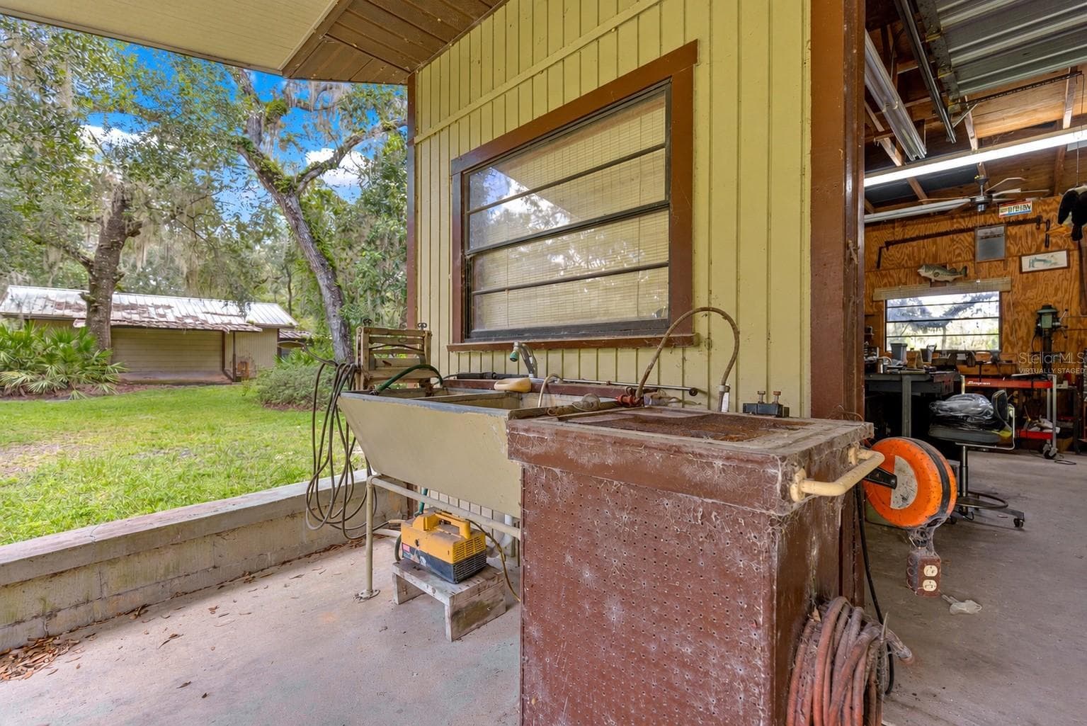 #2 · Exterior utility sink beside the mechanic’s shop. Virtually staged—personal items digitally removed. - 7434 E CABIN LN, INVERNESS