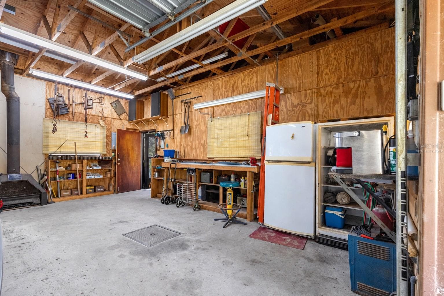 #2 · Mechanic’s shop reverse view and floor access panel. Virtually staged—personal items digitally removed. - 7434 E CABIN LN, INVERNESS