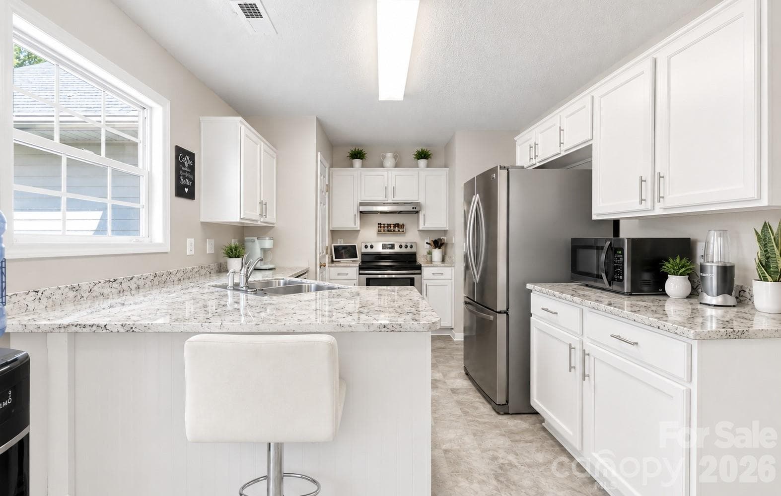 AI used to show If Cabinets were painted white and granite added. - 2116 Gambrel Way, Monroe