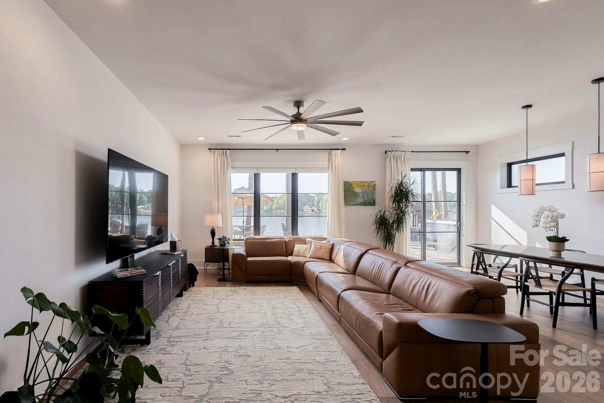 Lower level living room with lake views and exterior glass slider door - 298 Marietta Road, Mooresville