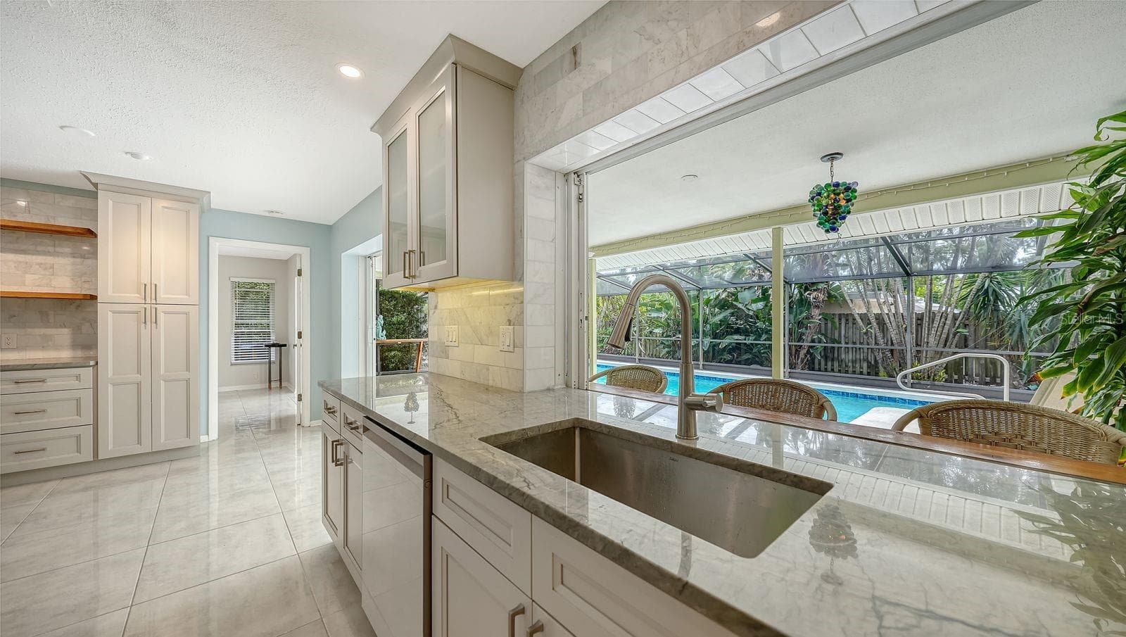 Kitchen Window slides open to the Lanai; great for entertaining guests! - 2295 PINE VIEW CIR, SARASOTA