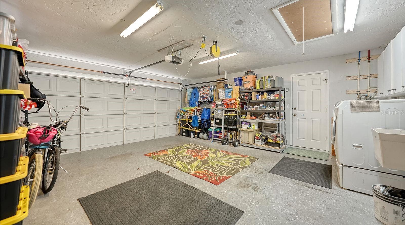 Spacious 2 Car Garage and a aluminum pull-down stairs to the attic. - 2295 PINE VIEW CIR, SARASOTA