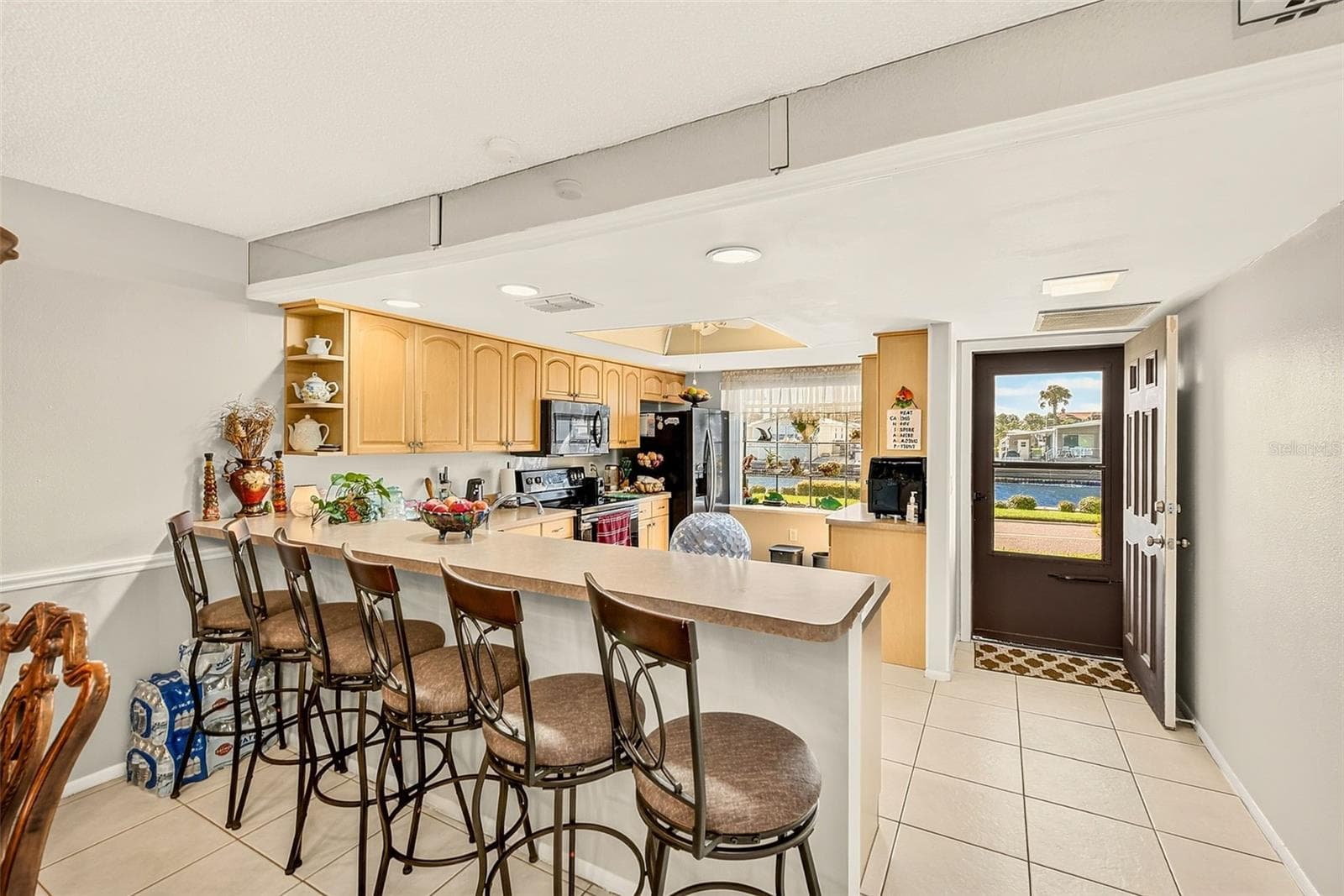 View of kitchen with bar stools - 19029 US HIGHWAY 19 N #21F, CLEARWATER