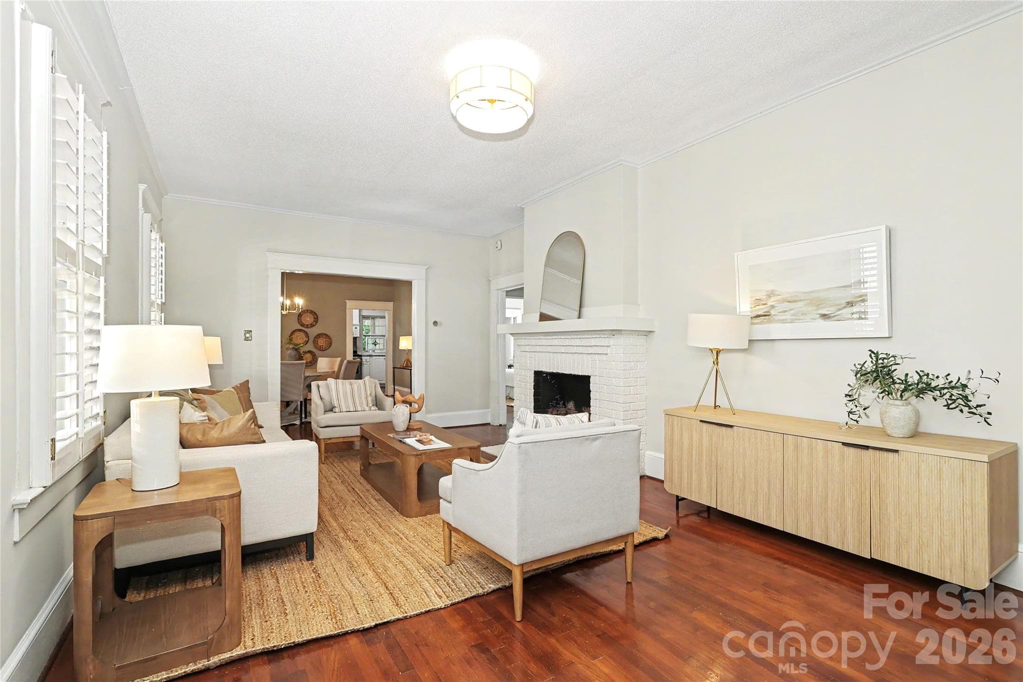 Spacious living room with high ceilings, hardwood floors and original fireplace - 1933 Park Road, Charlotte