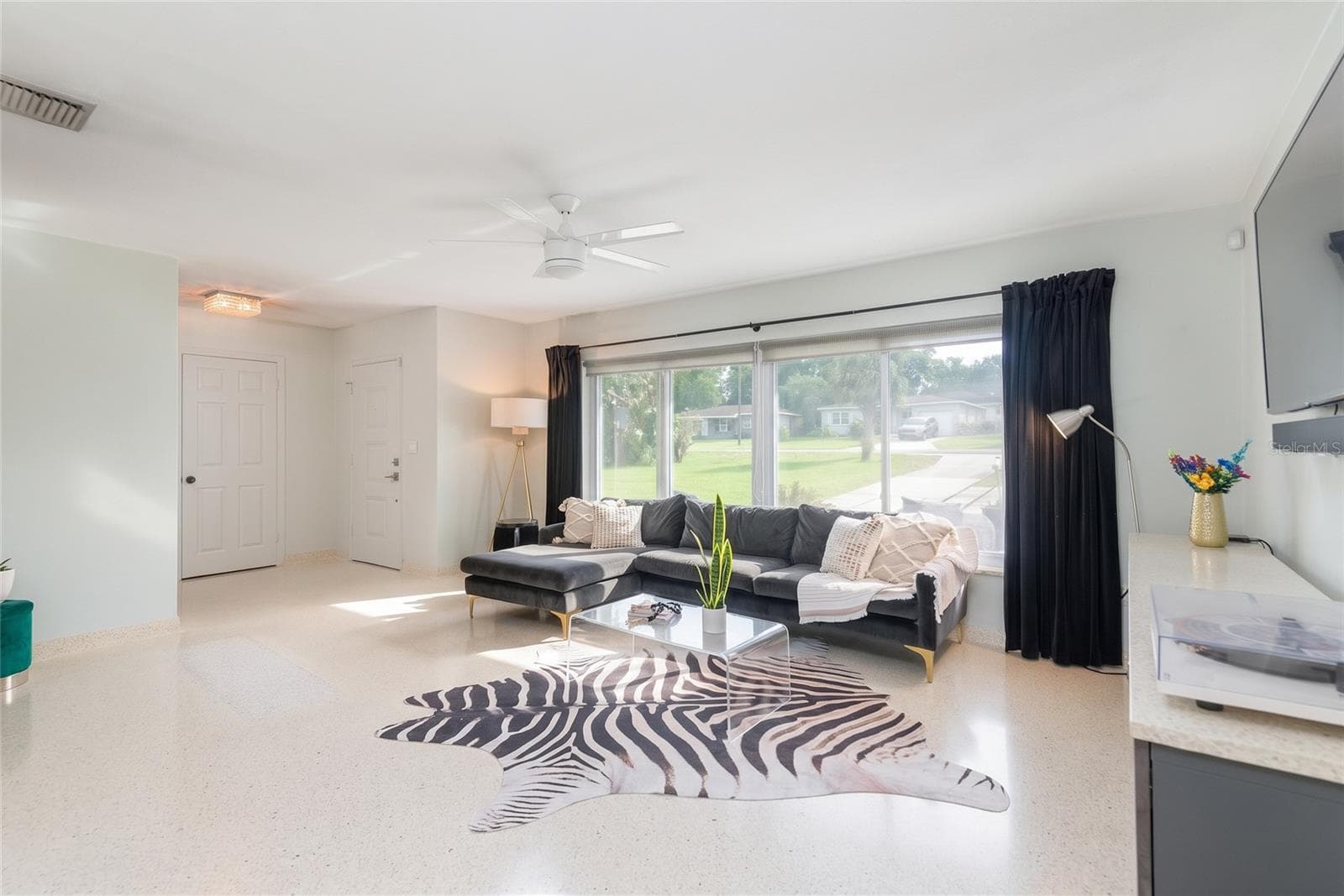 Custom poured terrazzo flooring (including base boards) flow throughout the home. Ready to compliment your decor no matter the style or color palette. - 7308 N OLA AVE, TAMPA