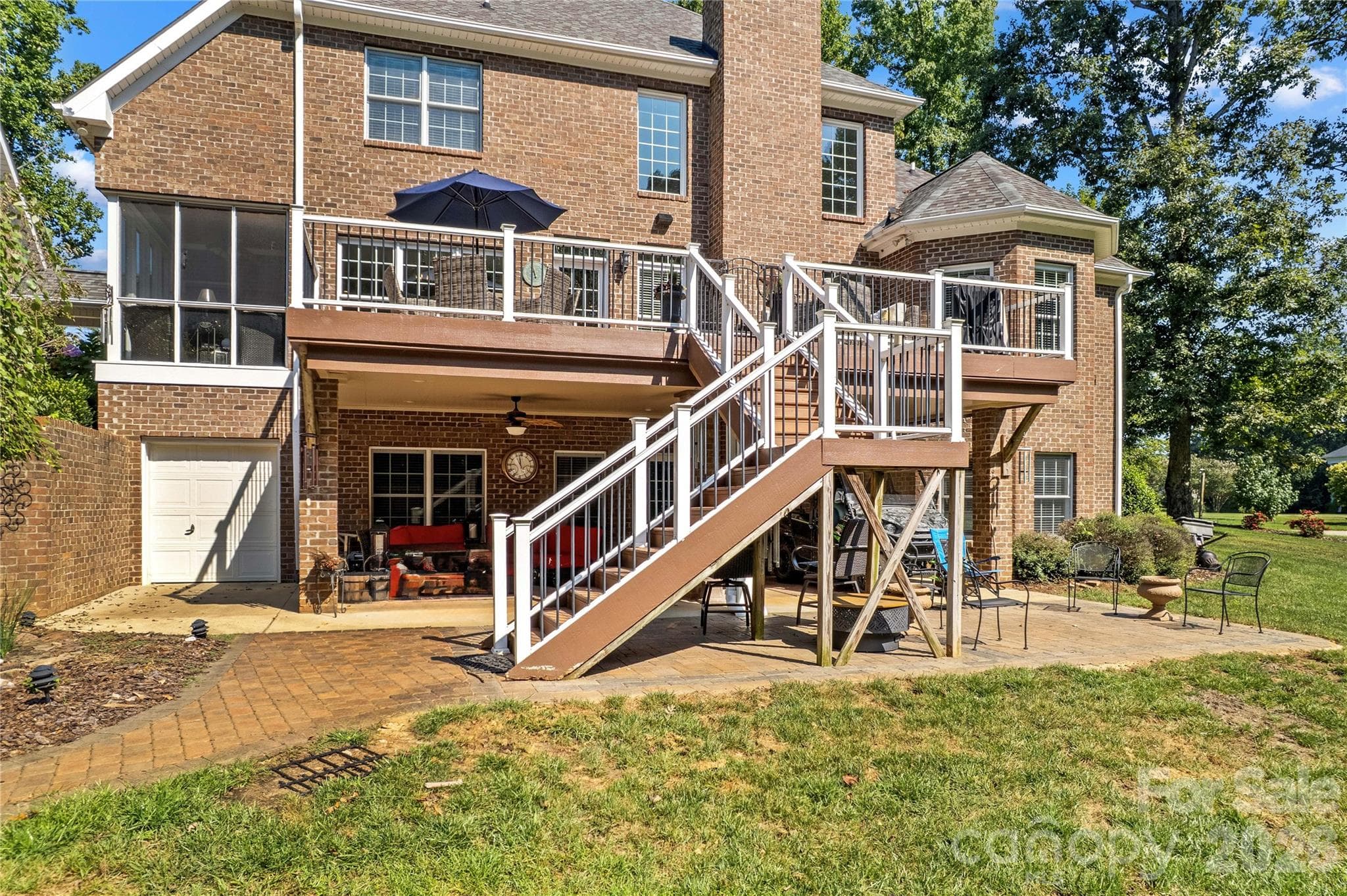 Back of home with covered patio, equipment garage access and large deck - 220 Cedar Lake Drive, Statesville